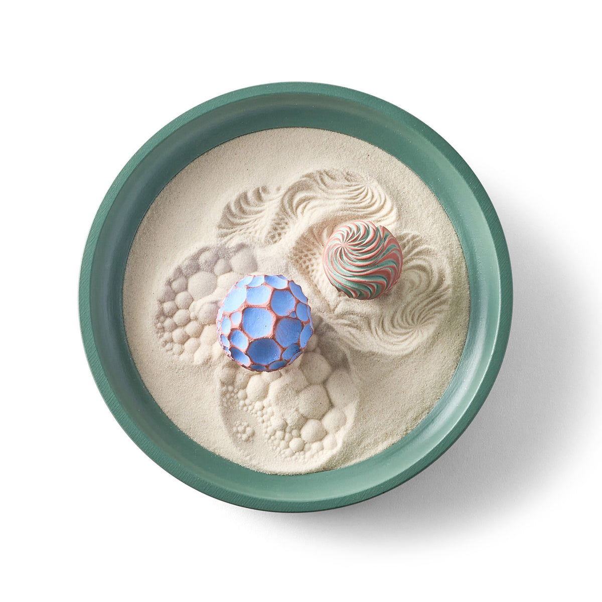 Top view of the Ebb & Ease Wonderscape with two colorful Sand Spheres in a green deep-dish tray of fine sand.