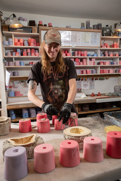 olander earthworks employee pouring concrete into silicone molds