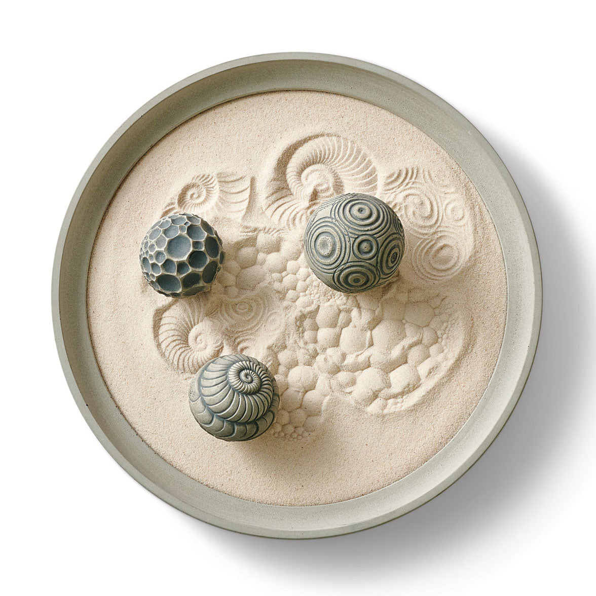 Top view of the Sound Affirmations Wonderscape with three patterned Sand Spheres in a round tray of fine sand.