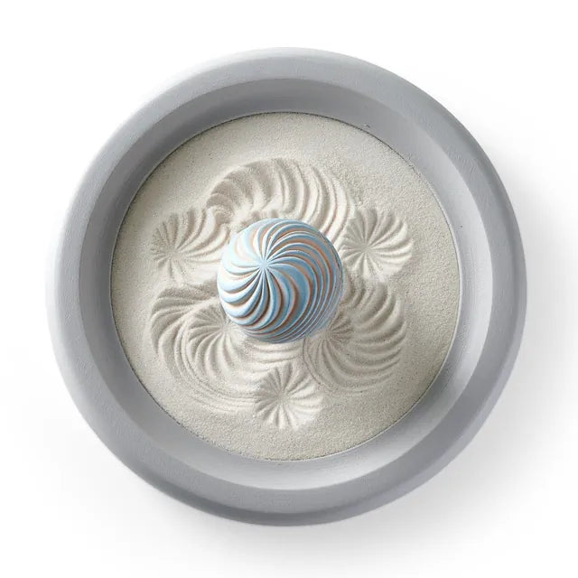 Morning Glow Wonderscape from above: a gray round tray of fine sand with one swirled Sand Sphere.