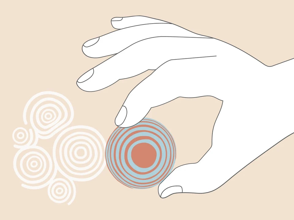 Drawing: a hand lifts a Sand Sphere from the sand, leaving round prints of its pattern.